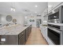 Spacious kitchen features a large island with granite countertops and modern appliances at 2907 Jakes View Pt, Fuquay Varina, NC 27526