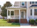 Inviting front porch with brick steps and ample seating space, perfect for relaxation at 3003 Cregler Dr, Apex, NC 27502