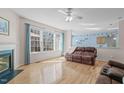 Bright and airy living room featuring hardwood floors, large windows, and a cozy fireplace at 3003 Cregler Dr, Apex, NC 27502