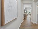 Bright hallway with hardwood flooring, leading into an open living and dining area at 3408 Dropseed Dr, Apex, NC 27502