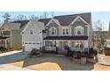 Beautiful two-story home with a two-car garage, inviting front porch, and manicured front yard at 3633 Jordan Shires Dr, New Hill, NC 27562