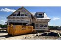 New construction of a two-story home featuring a dumpster on the property, ready for its final touches at 394 Springtooth Dr, Zebulon, NC 27597