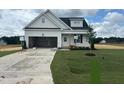 New construction shows a charming one-story home with white siding and a well-manicured green lawn at 394 Springtooth Dr, Zebulon, NC 27597