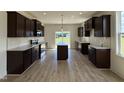 Beautiful kitchen with dark cabinets, stainless steel appliances, and a center island at 394 Springtooth Dr, Zebulon, NC 27597