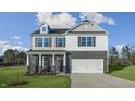 Inviting two-story home with gray brick, white siding and a two-car garage at 40 Granite Falls Way, Youngsville, NC 27596