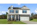 Inviting two-story home with gray brick, white siding and a two-car garage at 40 Granite Falls Way, Youngsville, NC 27596