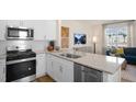 Modern kitchen boasts stainless steel appliances, granite countertops, and white cabinetry at 416 Belgian Red Way, Wake Forest, NC 27587