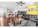 Spacious living room with hardwood floors, dark leather furniture, and neutral tones at 424 Hopwood Way, Apex, NC 27523