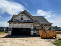 New construction home featuring a two-car garage and modern architectural details at 450 Springtooth Dr, Zebulon, NC 27597