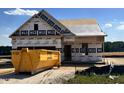 New home under construction featuring visible framing and a large dumpster at 450 Springtooth Dr, Zebulon, NC 27597