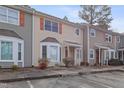 Townhouse exterior featuring neutral siding, updated windows, and a well-kept lawn at 519 Darby Glen Ln, Durham, NC 27713