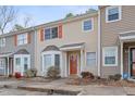 Townhouse exterior showcasing neutral siding, well-maintained landscaping, and a welcoming entrance at 519 Darby Glen Ln, Durham, NC 27713