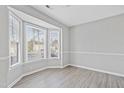 Bright living room featuring large bay window with natural light and neutral wall paint at 519 Darby Glen Ln, Durham, NC 27713