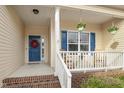 Welcoming front porch with classic columns, hanging plants, and comfortable seating at 55 Oak Leaf Dr, Lillington, NC 27546