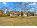 Lovely single-story home with a spacious front yard and mature trees, creating a serene setting at 5636 Thom Rd, Mebane, NC 27302