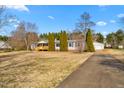 Exterior view featuring a long driveway, detached garage, and a well-maintained lawn and landscaping at 5636 Thom Rd, Mebane, NC 27302
