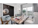 Cozy home office featuring a modern light fixture, a light wood desk, and picture window at 6028 Sodium St, Raleigh, NC 27610