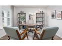 Comfortable home office featuring light wood desk, matching shelves and two gray armchairs at 6028 Sodium St, Raleigh, NC 27610