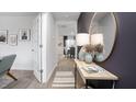 Inviting hallway with modern decor, leading to dining room, featuring stylish mirror and entry door at 6045 Sodium St, Raleigh, NC 27610