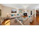 Bright living room with hardwood floors, fireplace, large windows, and comfortable seating for relaxation and gatherings at 6301 King Lawrence Rd, Raleigh, NC 27607