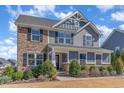 Beautiful home with a mix of stone and siding, enhanced by professional landscaping at 710 Legacy Falls S S Dr, Chapel Hill, NC 27517