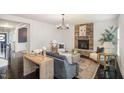 A cozy living room with a stone fireplace, neutral furniture, and an open entryway to the staircase at 710 Legacy Falls S S Dr, Chapel Hill, NC 27517