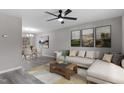 Inviting living room with modern decor, ceiling fan, and ample natural light at 8341 Wynewood Ct, Raleigh, NC 27616