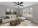 Bright living room with a large sectional sofa, decorative pillows, and a view of the neighborhood at 8341 Wynewood Ct, Raleigh, NC 27616
