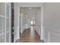 Inviting foyer with hardwood floors, wainscoting, and neutral paint at 84 Nonabell Ln, Four Oaks, NC 27524