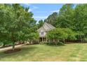 Charming two-story home with manicured lawn and mature trees on a sunny day at 94 Fawn Hill Ct, Garner, NC 27529