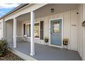 Inviting covered front porch with seating, stylish door, and plants for a welcoming entry at 1005 Helms Pl, Raleigh, NC 27610