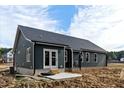 The rear exterior featuring a patio area accessible through sliding glass doors at 109 Averly Ct, Stem, NC 27581