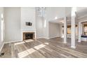 Bright living room with a fireplace, hardwood floors, high ceilings, and ample natural light at 112 Solstice Cir, Cary, NC 27513