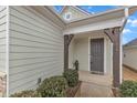 Inviting covered entrance with dark wood supports and a gray front door at 119 Canary Ct, Raleigh, NC 27610