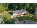 Aerial shot of a ranch-style home with a manicured lawn and mature trees surrounding the property at 1224 Manchester Dr, Raleigh, NC 27609