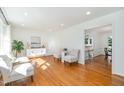 Bright living room with hardwood floors, neutral paint, and large windows offering ample natural light at 1224 Manchester Dr, Raleigh, NC 27609
