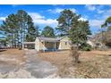 Charming single-Gathering home featuring a covered carport and mature trees in a quiet neighborhood at 1403 Fairground Road Rd, Dunn, NC 28334