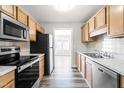 Modern kitchen with stainless steel appliances and wood cabinets at 1707 Stroll Cir, Fuquay Varina, NC 27526