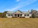 Quaint one-story home with a welcoming front porch and manicured landscaping at 1834 Dewitt Smith Rd, Pittsboro, NC 27312