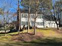 Traditional two-story home boasting white siding, black shutters, attached two-car garage, and landscaped front yard at 2006 Chedington Dr, Apex, NC 27502