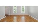Bright living room with hardwood floors, natural light, and neutral wall color at 2006 Chedington Dr, Apex, NC 27502