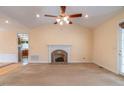 Bright living room featuring a fireplace, neutral carpet, and large windows at 2504 Churchill Dr, Burlington, NC 27215