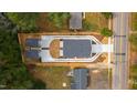 Birds eye view showing modern home featuring concrete driveway and landscaping at 2728 Milburnie Rd, Raleigh, NC 27610