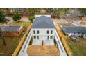 Aerial shot of gray two-story home with driveways on either side, new roof, and surrounding neighborhood at 2730 Milburnie Rd, Raleigh, NC 27610