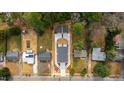 Bird's-eye view of the property with new gray roof, expansive driveway, and surrounding neighborhood at 2730 Milburnie Rd, Raleigh, NC 27610