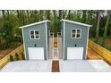 Exterior aerial view of two-story home with garages and staircase with modern design and landscaping at 2730 Milburnie Rd, Raleigh, NC 27610