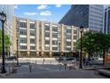 Street view of a multi-story building with modern architecture and street parking at 319 Fayetteville St # 509, Raleigh, NC 27601