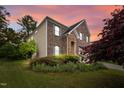 Charming brick home featuring a two-car garage, stone accents, and lush landscaping at 3614 Kilgo Dr, Durham, NC 27705