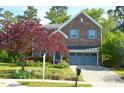 A lovely two-story home with brick, a well-kept lawn, and mature landscaping at 3614 Kilgo Dr, Durham, NC 27705
