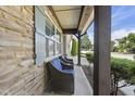 Inviting covered front porch with stone accents and comfortable seating, perfect for relaxing outdoors at 3621 Colby Chase Dr, Apex, NC 27539